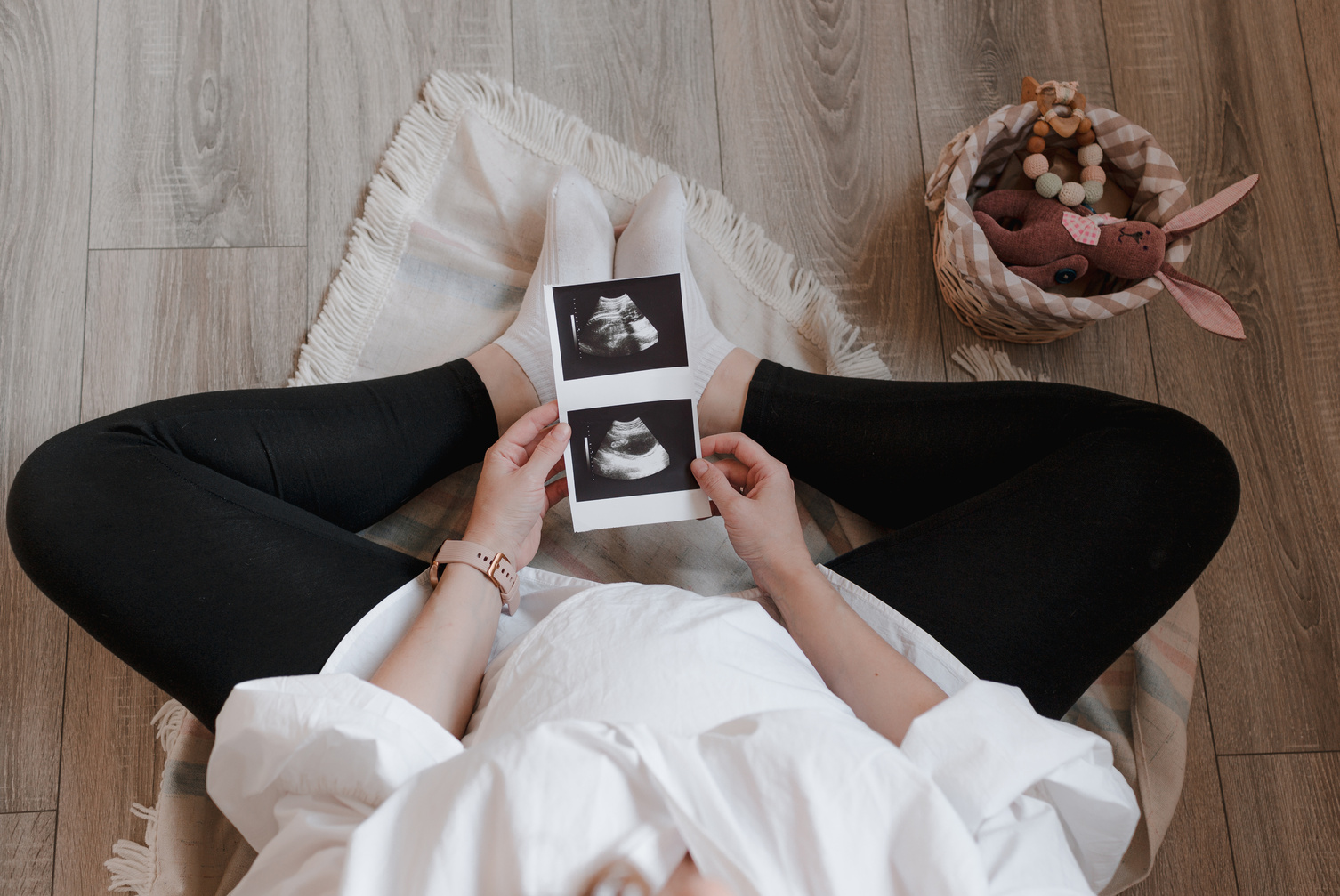 Pregnant Woman Holding Ultrasound Photos